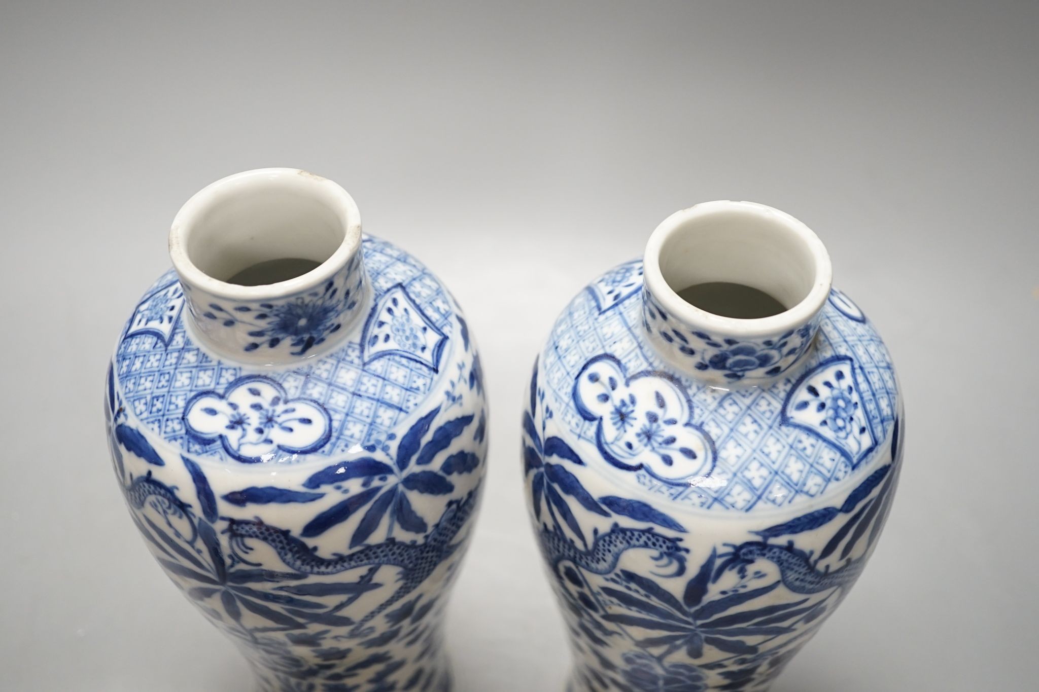 A pair of Chinese blue and white dragon vases and covers, circa 1900. 28cm